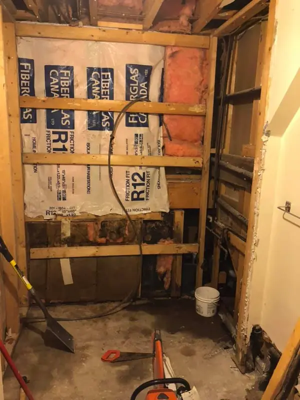Bathroom stripped down to reveal damaged areas