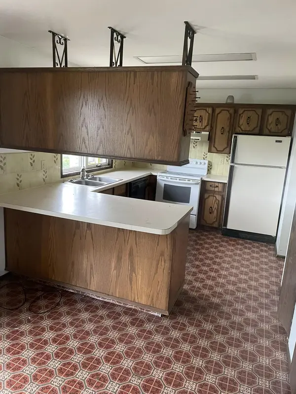 Kitchen mid-renovation with closets removed to open the floor plan