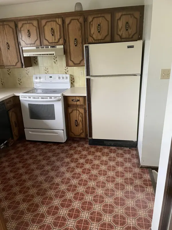 Finished kitchen with white cabinets to the ceiling, new countertops and flooring